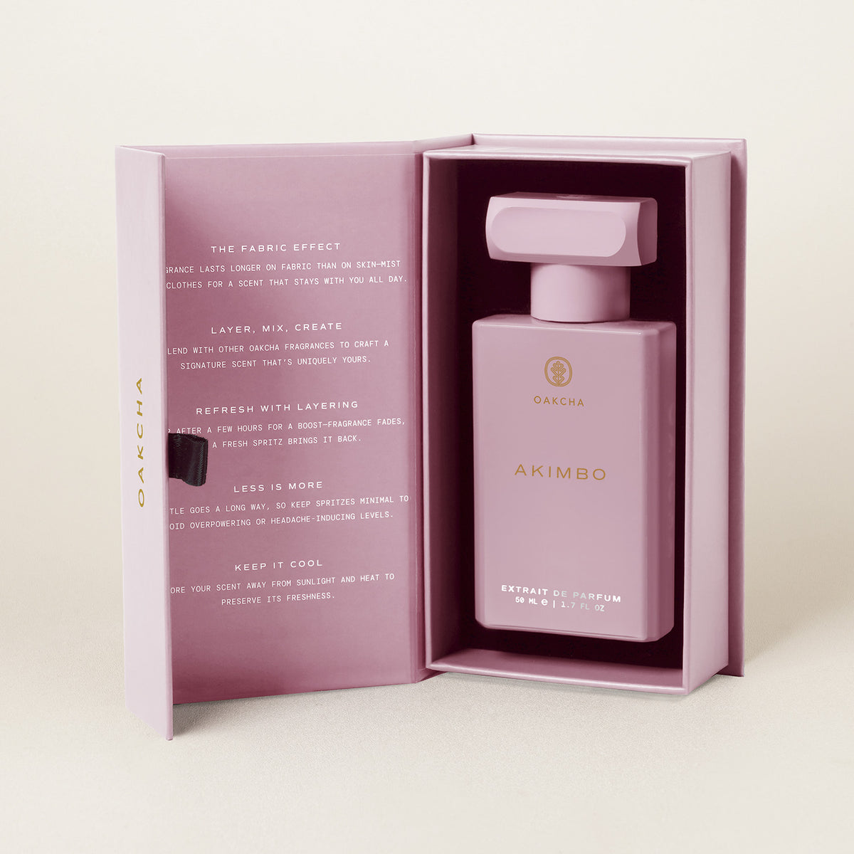Front view of Akimbo extrait de parfum bottle in pink packaging, 50 ml, with layering and storage tips