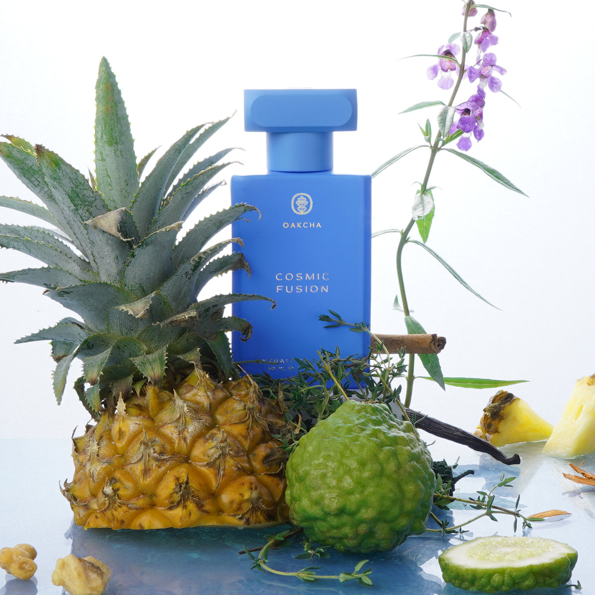 Front view of Cosmic Fusion perfume bottle, blue bottle with wooden cap and tropical fruits on white background