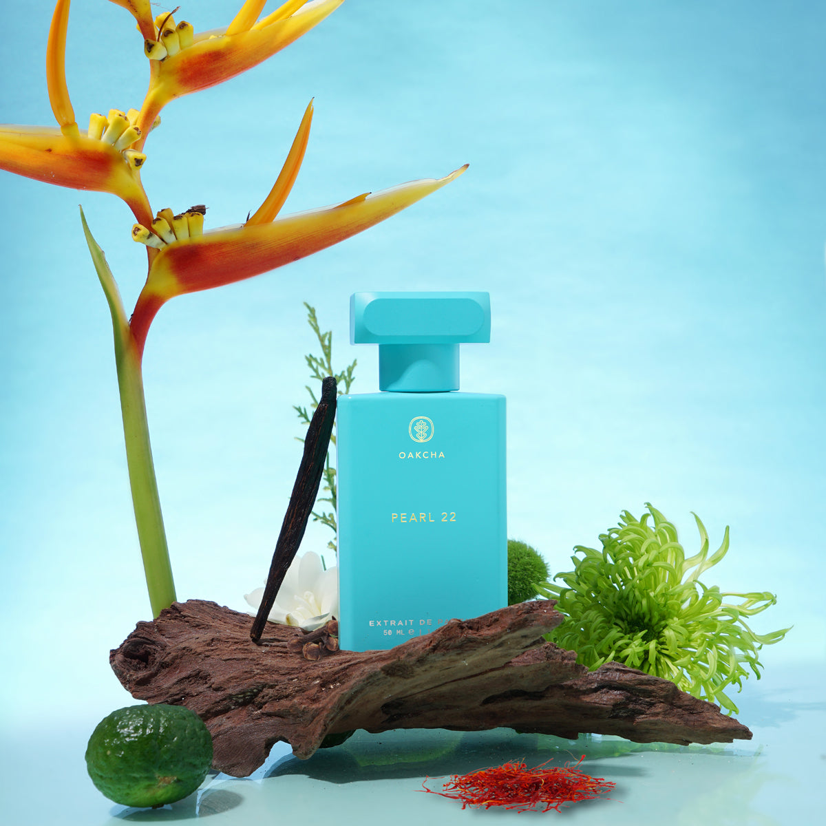 Front view of Pearl 22 perfume bottle showcasing turquoise rectangular bottle with gold logo and blue studio background