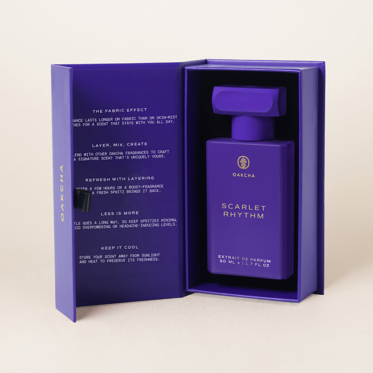 Front view of Scarlet Rhythm 50 ml extrait de parfum bottle showcasing its purple design in an open purple presentation box