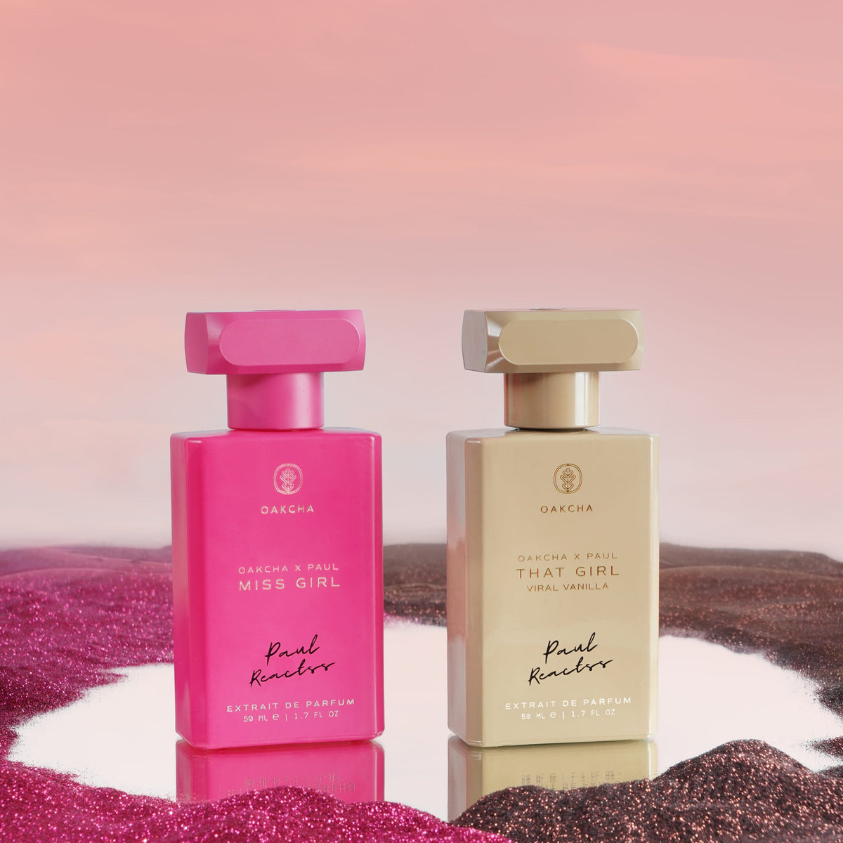 Front view of Paul Reactss The Girls with pink Miss Girl and beige That Girl Extrait de Parfum bottles on glitter